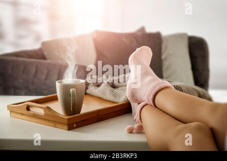 Woman’s legs in socks on the background of the spring window with space for an advertising product. Stock Photo