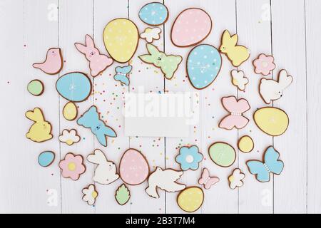 Easter greeting card with gingerbread cookies. Easter spring decorative composition with homemade easter cookies in shape of funny rabbit and eggs Stock Photo