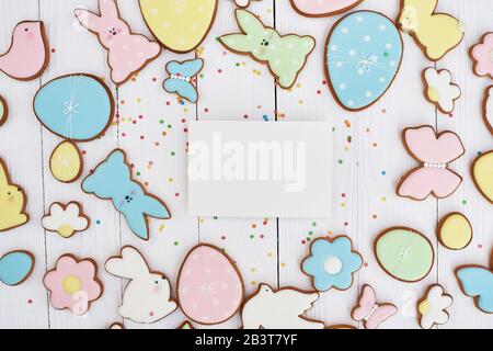 Easter greeting card with gingerbread cookies. Easter spring decorative composition with homemade easter cookies in shape of funny rabbit and eggs Stock Photo