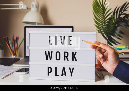 Live Work Play concepts with text on light box on desk table in home office.Life balance.positive emotion to success Stock Photo
