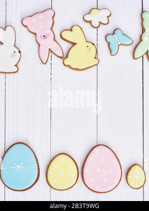 Easter greeting card with gingerbread cookies. Easter spring decorative composition with homemade easter cookies in shape of funny rabbit and eggs Stock Photo