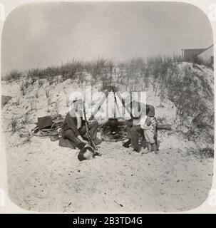 Antique 1898 photograph, Victorian men with shotgun and young boy at their beach encampment at Long Beach, New York. SOURCE: ORIGINAL PHOTOGRAPH Stock Photo