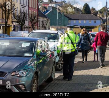 Traffic warden on patrol in Bandon, West Cork, Ireland Stock Photo