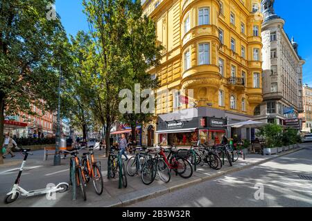 Bicycles on narrow street and typical historic buildings in old city of Vienna - capital and largest city of Austria. Stock Photo