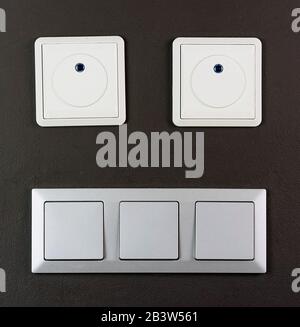 Electrical switch and plug on wall smile face Stock Photo