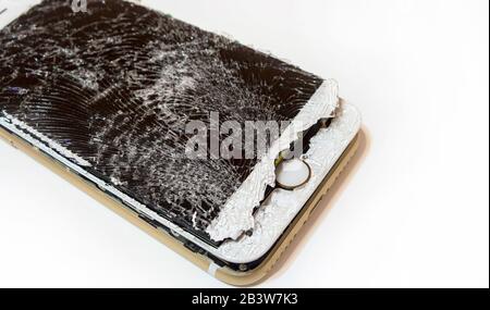 Modern smartphone with highly broken screen isolated on white background. Stock Photo