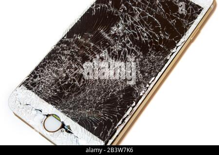 Modern smartphone with highly broken screen isolated on white background. Stock Photo