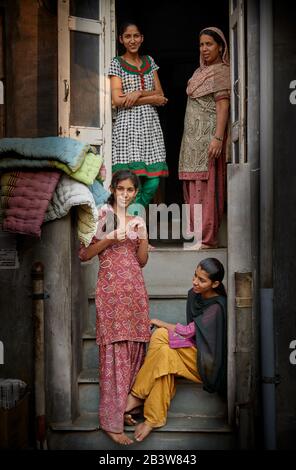 four beautiful Indian women and girls on the steps to their home in Bikaner, Rajasthan, India Stock Photo