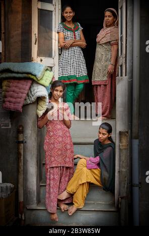 four beautiful Indian women and girls on the steps to their home in Bikaner, Rajasthan, India Stock Photo