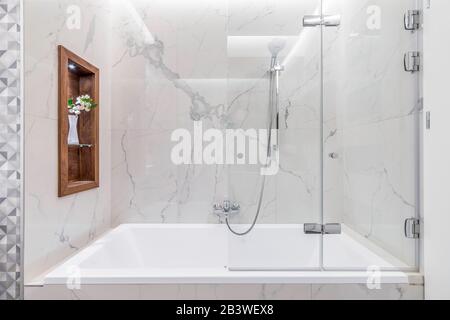 Budapest, Hungary - April 18, 2019: Luxurious white marble bathroom in an Airbnb accommodation, straight view. Stock Photo