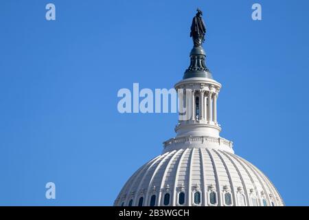 Closeup of US Capital Building Dome with the back of the bronze Statue of Freedom seen on clear day. Stock Photo