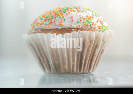 Easter cake wrapped in white paper. Side view, closeup. Stock Photo