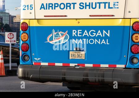 Reagan Washington National Airport logo on the back on an airport shuttle while stopped at a Terminal. Stock Photo