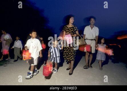 Austin, Texas USA: Parents and children carry lanterns while walking to Vietnamese cultural fall celebration at Walnut Creek Elementary School, which has a large number of Vietnamese and Vietnamese-American families in its attendance district. ©Bob Daemmrich Stock Photo