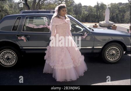 Austin, Texas USA: Young honoree poses in pink ballgown at her quinceanera, a traditional 15th birthday Catholic coming-out celebration for girls.  MR (EC-0011,12)   ©Bob Daemmrich. Stock Photo