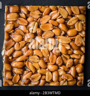 Directly above shot of peanut brittle on black background Stock Photo
