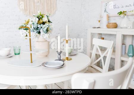 White kitchen cupboard with glasses, cups and bowls. Pastelles Stock Photo  - Alamy