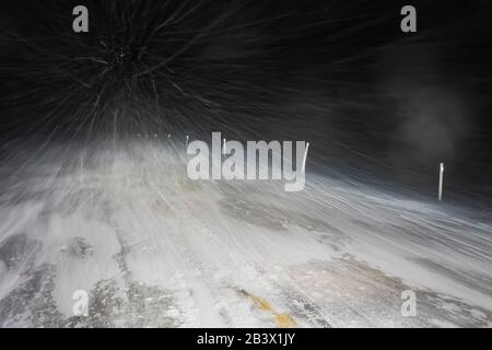 Driving through a snow squall blizzard along a highway on the Avalon Peninsula south of St. John's, Newfoundland, Canada Stock Photo