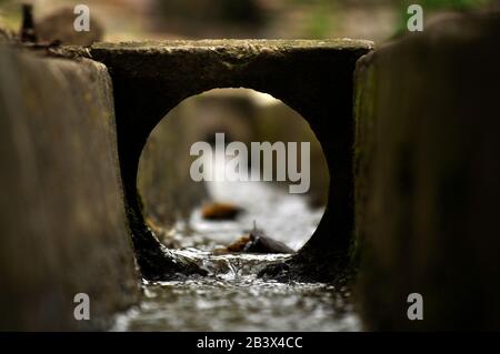 Water flow running inside an artificial channel/ Abstract imagery for book covers Stock Photo