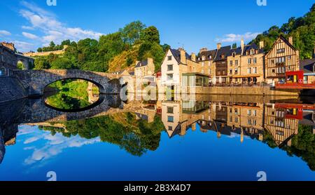 The Old stone bridge and historical medieval houses reflecting in La Rance river in Dinan town port, Brittany, France Stock Photo