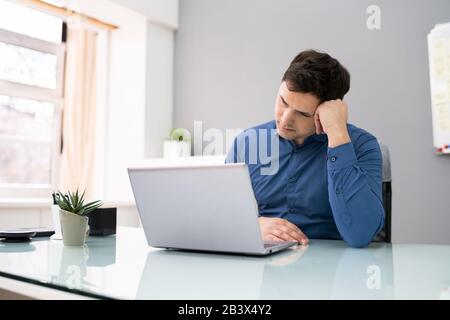 Photo Of Tired Mature Businessman Sleeping In Office Stock Photo