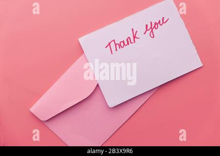 thank you letter and envelope on pink background  Stock Photo