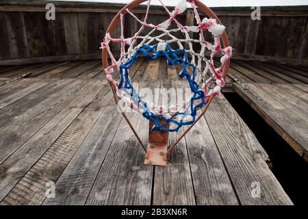 Basketball hoop with net from below on wooden wall Stock Photo