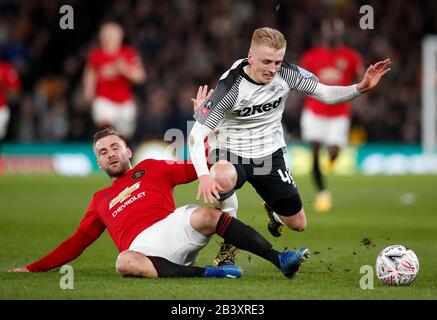 Manchester United's Luke Shaw challenges Derby County's Louie Sibley (right) during the FA Cup fifth round match at Pride Park, Derby. Stock Photo