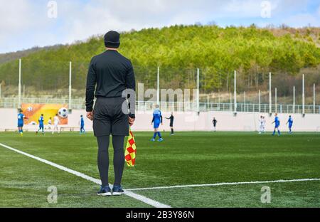 referee on the field during a football match Stock Photo