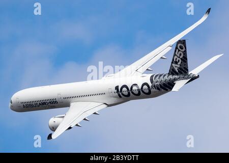 Farnborough, UK - July 17, 2018: Airbus flies the A350-1000 XWB at the Farnborough Int'l Airshow, in the colors of Qatar Airways as launching customer Stock Photo