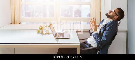 Close-up Of A Businessman Relaxing At Workplace Stock Photo