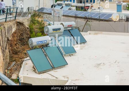 Bali, Crete, Greece -10.09.2019: solar water heaters on the roofs of houses. Stock Photo