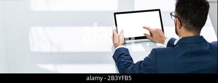 Close-up Of A Businessman's Hand Using Laptop With Blank White Screen Stock Photo