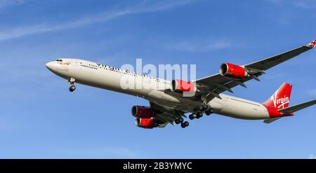 LONDON, ENGLAND - NOVEMBER 2018: Virgin Atlantic Airbus A340 coming into land at London Heathrow Airport. Stock Photo