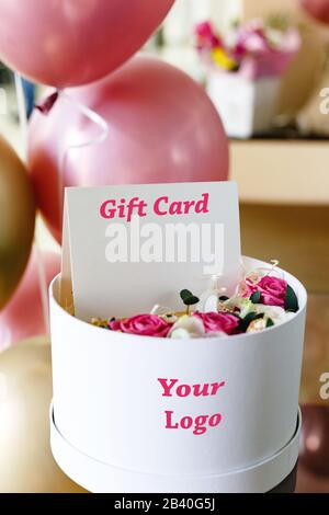 Blank card in flower box. Greeting card, gift card with empty space for your design, logo, mock up for mothers day, womens day, birthday Gift bouquet Stock Photo