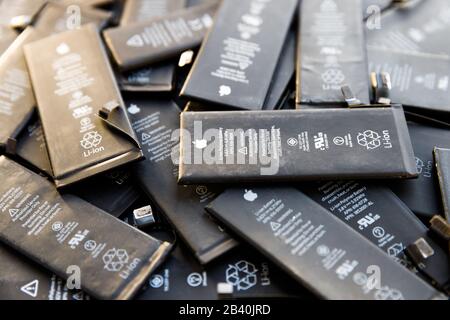 St. Petersburg, Russia - December 2, 2019: Close up of old used Li-ion Polymer batteries of Apple iPhone preparation for recycling Stock Photo