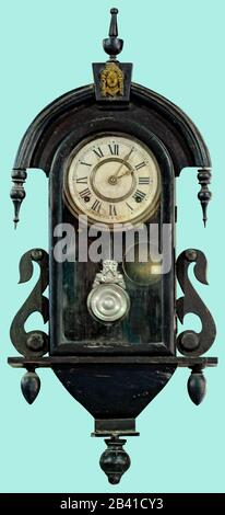 Antique swing wall clock. Pendulum clock on isolated green background with clipping path. Stock Photo