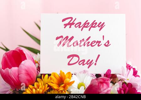 Happy Mothers Day text on white background with flower bouquet of pink ...