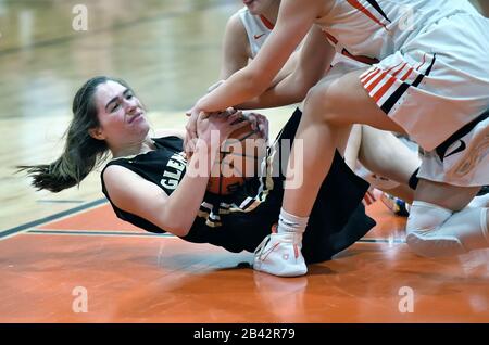 Two players in a floor tussle that resulted in a held ball call and jump ball whistle. USA. Stock Photo