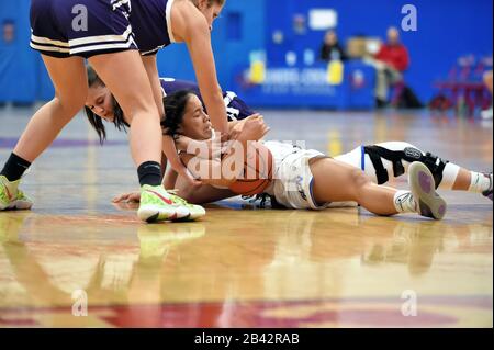 Two players in a floor tussle that resulted in a held ball call and jump ball whistle. USA. Stock Photo