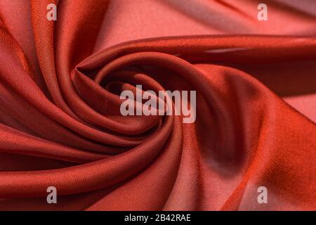 Shiny red cloth background dark curly background Stock Photo