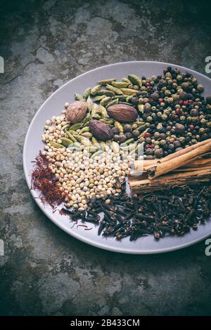 Aromatic spices on a plate on slate with a vintage filter Stock Photo