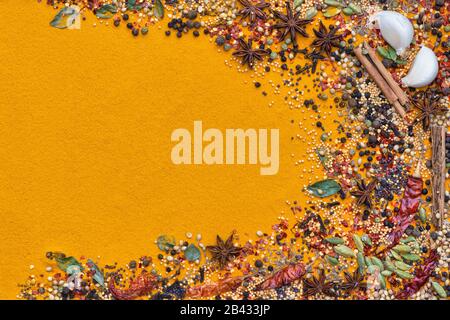 Aromatic spices with a turmeric powder base to side of the frame Stock Photo
