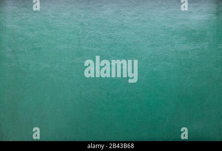 a natural green leather texture. close up.texture background with leather lines markings effect, full frame. Close up detail of textured sheet of Stock Photo