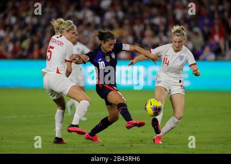 Orlando, Florida, USA. 5th Mar, 2020. United States forward CARLI LLOYD (10) competes for the ball against England defender STEPH HOUGHTON (5) and England defender LEAH WILLIAMSON (14) during the SheBelieves Cup United States vs England match at Exploria Stadium in Orlando, Fl on March 5, 2020. Credit: Cory Knowlton/ZUMA Wire/Alamy Live News Stock Photo