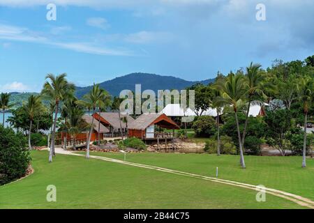 Holiday resort restaurant buildings by the beach with a road leading to them across a small bridge, situated on the coast of Australia Stock Photo