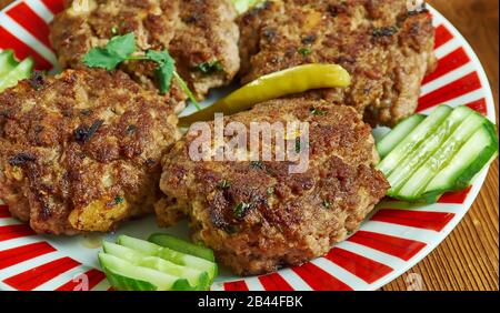 Shami kebab, variety of kebab, originating from the Indian subcontinent,  Awadhi cuisine, Traditional assorted Indian  dishes, Top view. Stock Photo