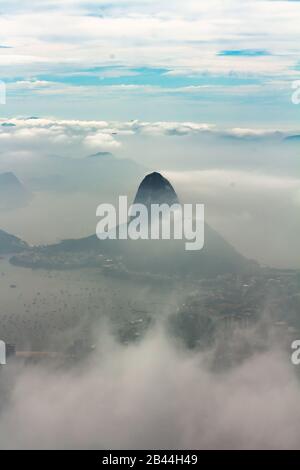 Through the misty sky of Brazil we see the Sugar loaf mountain peeking out. Stock Photo