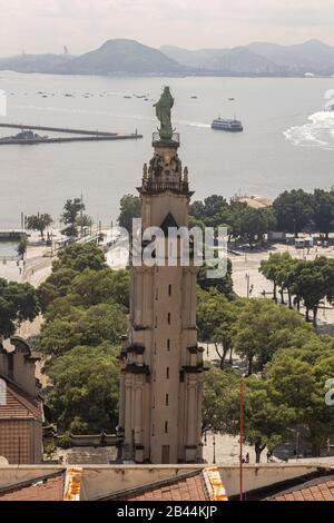 City centre port area with the Dom João VI statue monument and XV Square in the foreground and ferry boats to and from Niteroi in the background Stock Photo