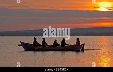 Portobello, Edinburgh, Scotland, UK. 6th March 2020. Minus 1 centigrade with beautiful sunrise for the crew of The Sprite taking their rowing boat out for regular dawn trip on the Firth of Forth. Stock Photo